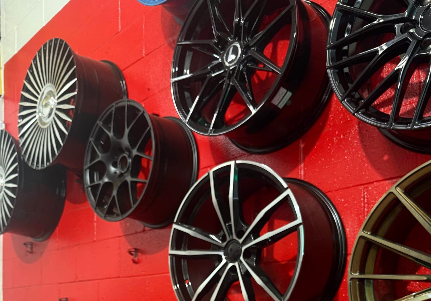 Alloy rims on the wall at Boss Tire