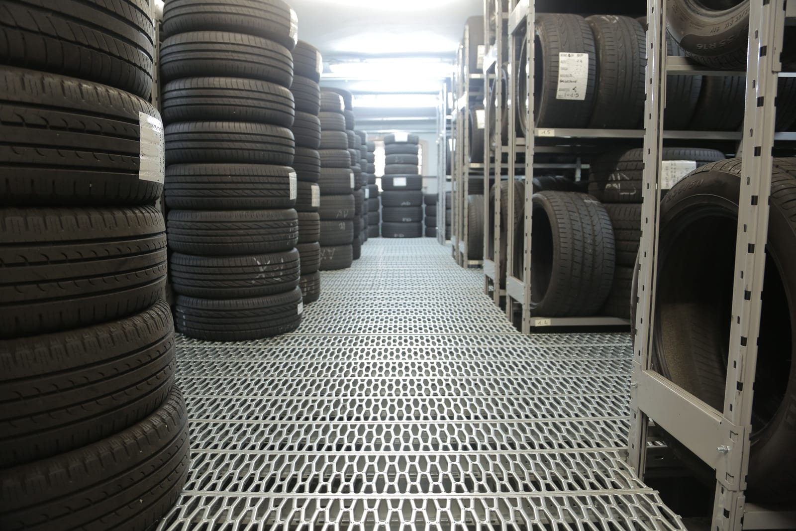 Rows of new and used tires stocked in the shop